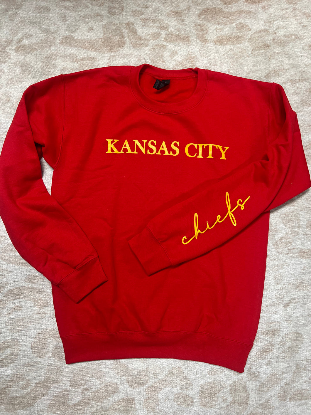 KC red crew with wording on sleeve